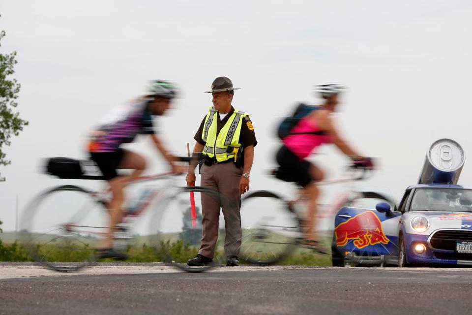 Sgt. Scott Bright with the Iowa State Patrol directs riders on the route Wednesday, July 26, 2017, on the fourth day of RAGBRAI.