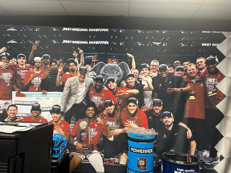 A celebration photo of Alabama’s NCAA West Region title made up this entire wall in the Crimson Tide’s Final Four locker room at State Farm Stadium.