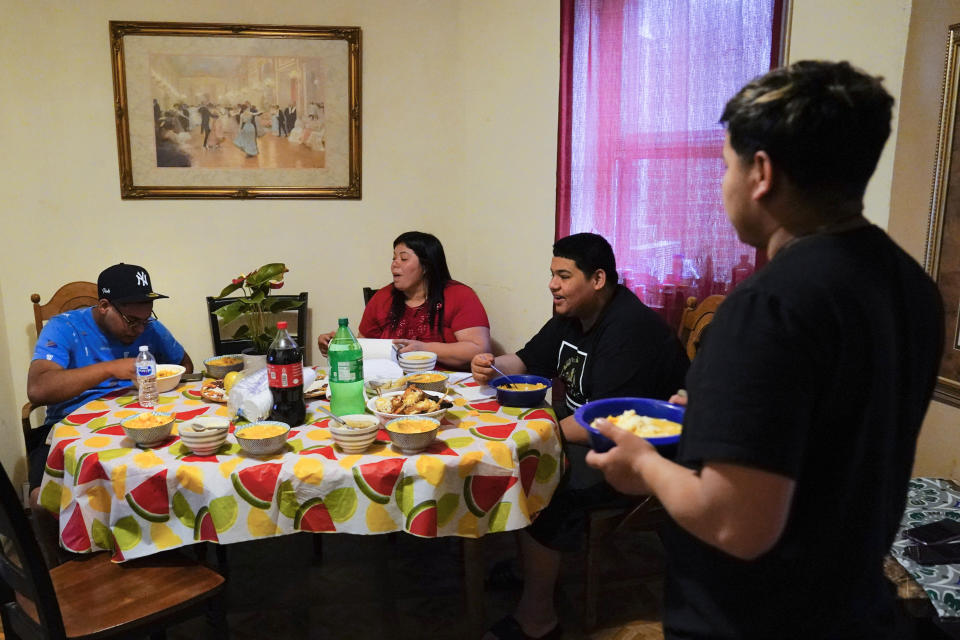 Keldy Mabel Gonzales Brebe, 37, sits for lunch with her sons, from left, Mino Zuniga Gonzales, 19, Erick Zuniga Gonzales, 17, and Alex Zuniga Gonzales, 21, in the Kensington section of Philadelphia, Sunday, May 16, 2021. Gonzales Brebe, a 37-year-old Honduran immigrant, and her two teenage sons are trying to rebuild their lives together after they were separated under a former "zero-tolerance" policy to criminally prosecute adults who entered the country illegally. (AP Photo/Matt Rourke)