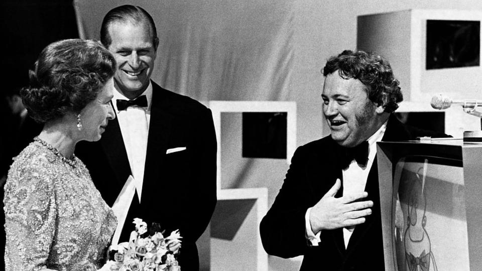 The comedian Harry Secombe jokes with the Queen and the Duke of Edinburgh at the BBC Television Centre, 1973. | Location: Wood Lane, Shepherd's Bush, London, England, UK