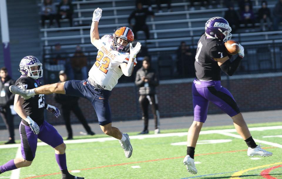 Mount Union's Jesse Vail, right, intercepts a pass intended for Utica's Tobey Callender, left, during an NCAA Division III playoff game on Saturday, November 26, 2022.