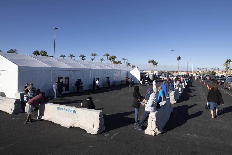 Voters wait for an early voting site to open during the first day of early voting in Henderson, Nev. Saturday, Oct. 17, 2020. (Steve Marcus/Las Vegas Sun via AP)