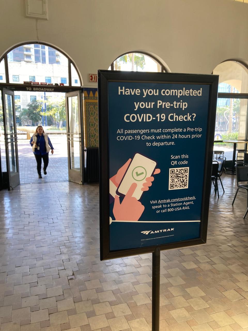 A sign at the Santa Fe Depot train station in San Diego reminds travelers to complete a pre-trip COVID-19 check.