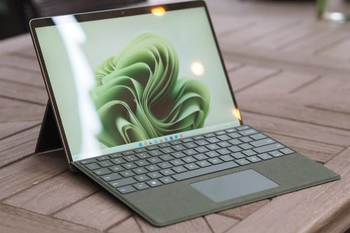 The green Surface Pro 9 open on the ground.