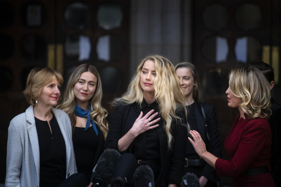 Actress Amber Heard, alongside her sister Whitney Henriquez (second right) and lawyer Jen Robinson (right), as she gives a statement outside the High Court in London on the final day of hearings in Johnny Depp's libel case against the publishers of The Sun and its executive editor, Dan Wootton. After almost three weeks, the biggest English libel trial of the 21st century is drawing to a close, as Mr Depp's lawyers are making closing submissions to Mr Justice Nicol. (Photo by Victoria Jones/PA Images via Getty Images)