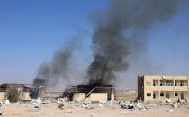 Smoke rises from a military supply post after it was hit by an air strike in Yemen's northwestern city of Saada April 1, 2015. REUTERS/Naiyf Rahma