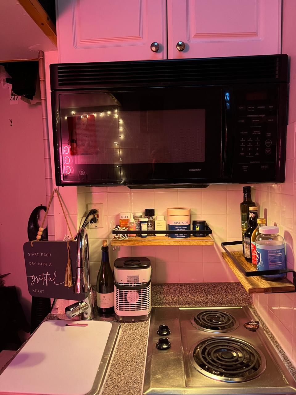 The kitchen of Alaina Randazzo's $650/month apartment, showing a microwave and two-burner stovetop