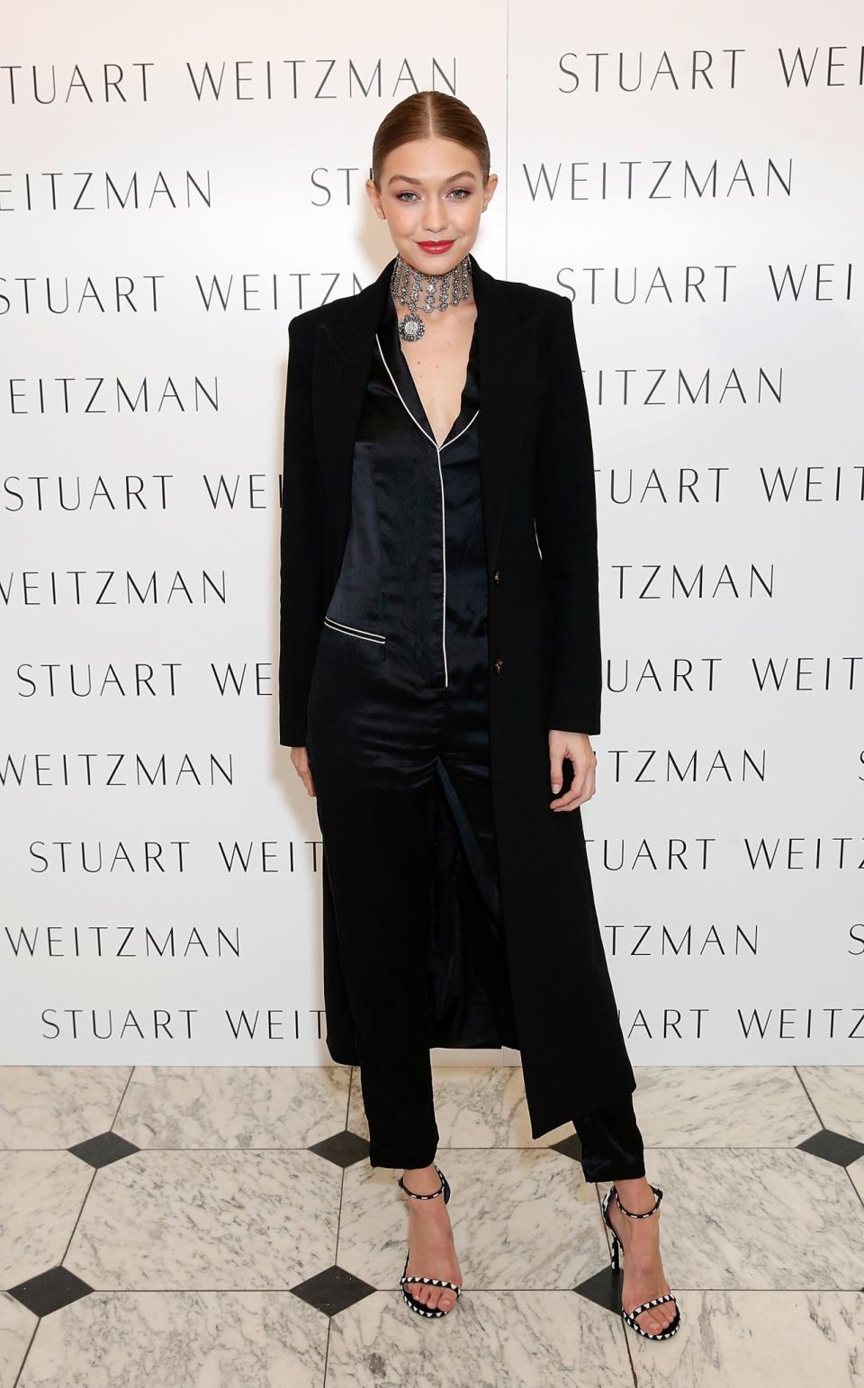 Gigi Hadid wears a Fleur du Mal silk pajama jumpsuit at a Stuart Weitzman event in London.