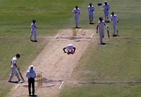 Cricket - Australia v South Africa - First Test cricket match - WACA Ground, Perth, Australia - 7/11/16. South Africa's Kagiso Rabada kisses the pitch as he celebrates taking his fifth wicket after dismissing Australia's Mitchell Starc at the WACA Ground in Perth. REUTERS/David Gray