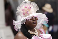 A race fan walks through the grounds of Churchill Downs before the 150th running of the Kentucky Oaks horse race Friday, May 3, 2024, in Louisville, Ky. (AP Photo/Abbie Parr)