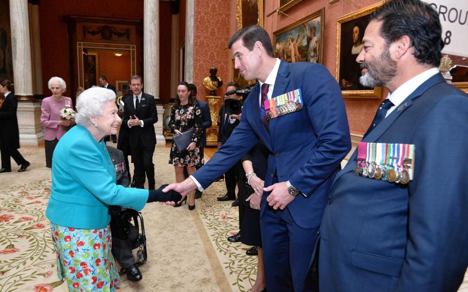 Queen Elizabeth II shakes hands with Ben Roberts-Smith who was awarded the Victoria Cross - JOHN STILLWELL/AFP