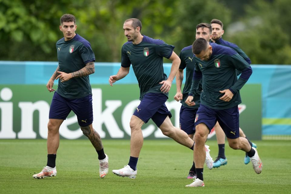 Italy's Giorgio Chiellini, center, runs during a training session at Tottenham Hotspur training ground in London, Saturday, July 10, 2021 ahead of the Euro 2020 soccer championship final match against England at Wembley Stadium on Sunday. (AP Photo/Frank Augstein)