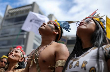 People protest outside the Brazilian embassy due to the wildfires in the Amazon rainforest, in Bogota