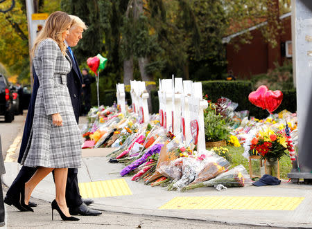 U.S. President Donald Trump and first lady Melania Trump pay their respects at a makeshift memorial outside the Tree of Life synagogue in the wake of the shooting at the synagogue where 11 people were killed and six people were wounded in Pittsburgh, Pennsylvania, U.S., October 30, 2018. REUTERS/Kevin Lamarque