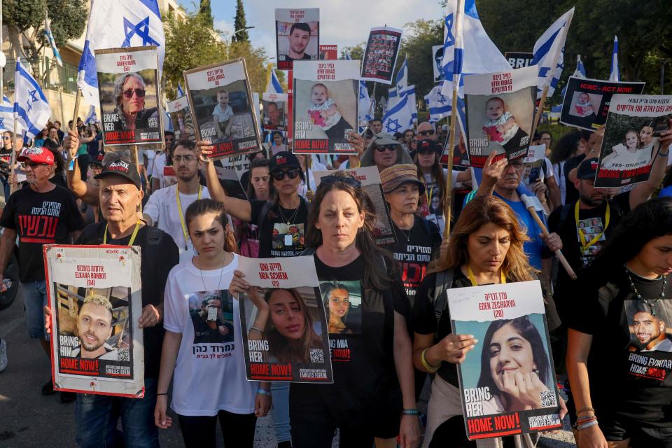 Relatives, friends and supporters of Israeli hostages held in Gaza since the October 7 attack by Hamas militants in southern Israel, hold placards and images of those taken during a protest for their release in the central city of Modiin on November 16 2023, as they march towards Jerusalem.