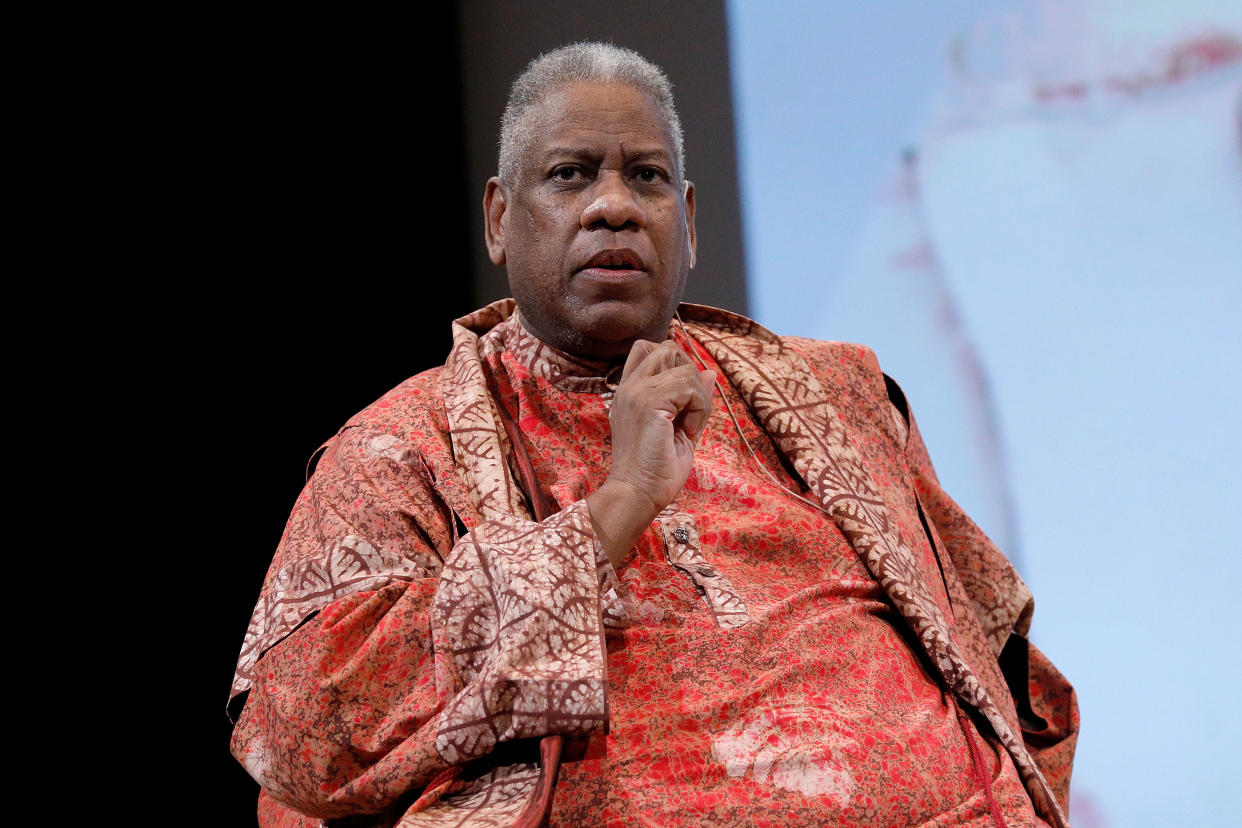 Andre Leon Talley looks thoughtful in a reddish orange caftan of sorts with short white and gray hair (Taylor Hill / Getty Images)