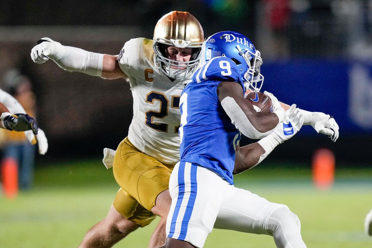 Sep 30, 2023; Durham, North Carolina, USA; Duke Blue Devils running back Jaquez Moore (9) tries to elude Notre Dame Fighting Irish linebacker JD Bertrand (27) during the second quarter at Wallace Wade Stadium. Mandatory Credit: Jim Dedmon-USA TODAY Sports