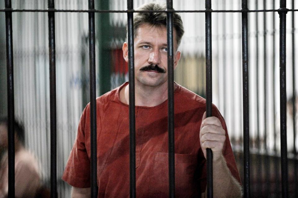 Russian arm dealer Viktor Bout looks from behind bars at the Criminal Court in Bangkok on October 10, 2008.