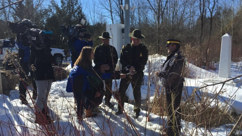 'We're all humans': U.S. border agent watches as asylum seekers cross into Canada