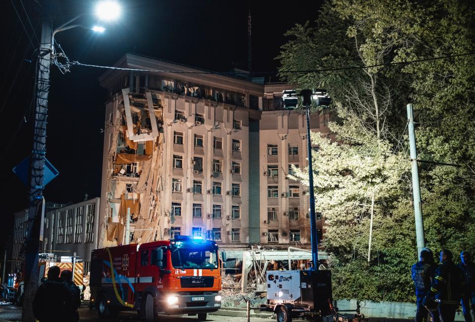 Ukrainian rescuers work at the site of a damaged administrative building after shelling in Dnipro (EPA)