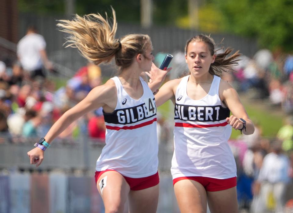 Gilbert's Avery Bruner makes the exchange with Rebecca Schrader during the Class 3A girls distance medley relay at the Iowa High School state track and field championships at Drake Stadium in Des Moines on Friday, May 19, 2023.
