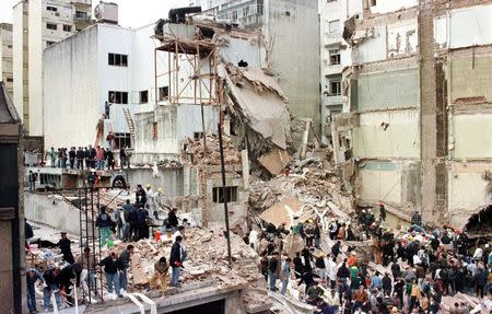 Rescue workers search for survivors and victims in the rubble after a powerful car bomb destroyed the Buenos Aires headquarters of the Argentine Israelite Mutual Association (AMIA), in this July 18, 1994 file photo. REUTERS/Files/Enrique Marcarian