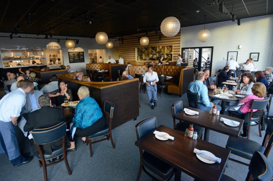 People enjoy dinner and drinks during the official opening night for Ocean Blue Restaurant & Oyster Bar in the Landmarc Building Thursday, Oct. 1, 2015.