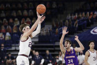 Gonzaga forward Corey Kispert, left, shoots next to Northwestern State forward Robert Chougkaz during the first half of an NCAA college basketball game in Spokane, Wash., Monday, Dec. 21, 2020. (AP Photo/Young Kwak)