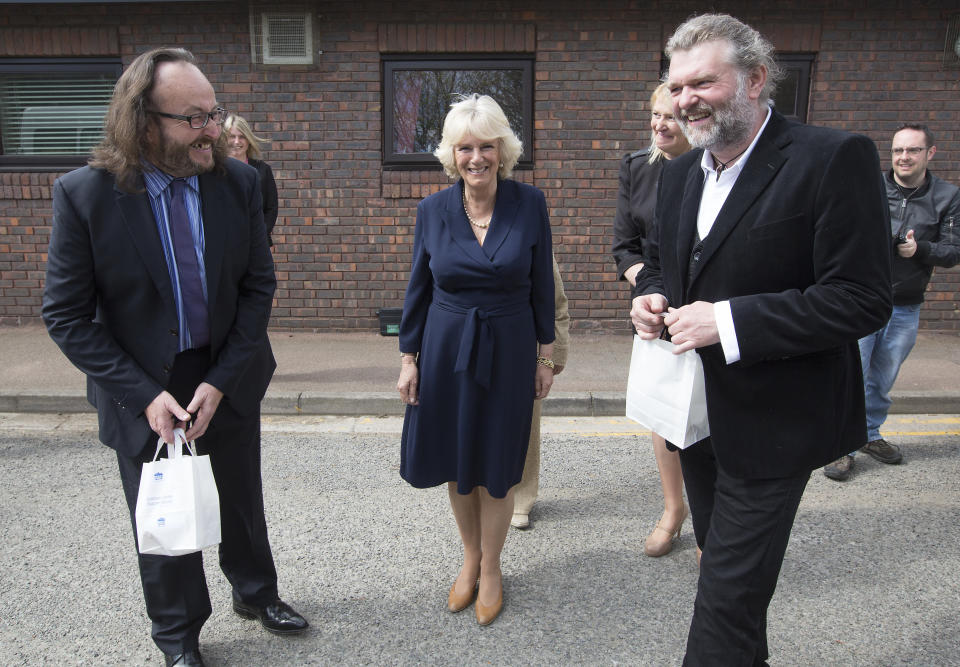 COBHAM, UNITED KINGDOM - APRIL 24:  Camilla, Duchess of Cornwall (L), walks with celebrity chefs, 'The Hairy Bikers,' Simon King (R) and David Myers (L) during her visit to a Community Centre run by Elmbridge Borough Council on April 24, 2013 in Cobham, Surrey, England.  The celebrity chefs are campaigning to revive 'Meals on Wheels' services for pensioners with the help of The Duchess.  (Photo by Richard Pohle - WPA Pool/Getty Images)