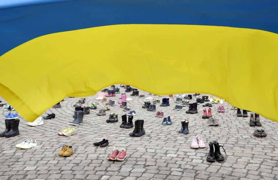 Children's shoes are seen during a demonstration organized by the Ukrainian Association in Finland, to honor the memory of the children killed in Mariupol, Ukraine, in Helsinki, on April 10, 2022. - - Finland OUT (Photo by Jussi Nukari / Lehtikuva / AFP) / Finland OUT (Photo by JUSSI NUKARI/Lehtikuva/AFP via Getty Images)