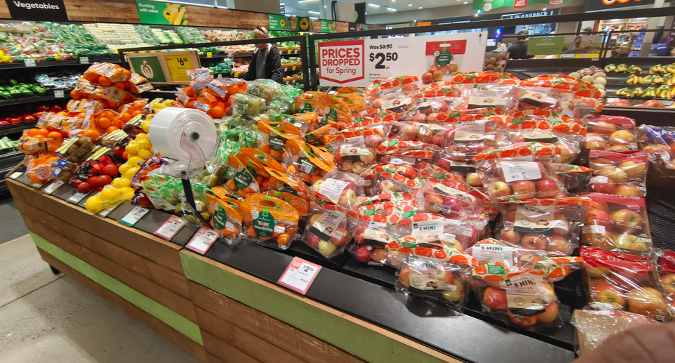 The produce section at a Woolies store showing plastic covered fruit. 