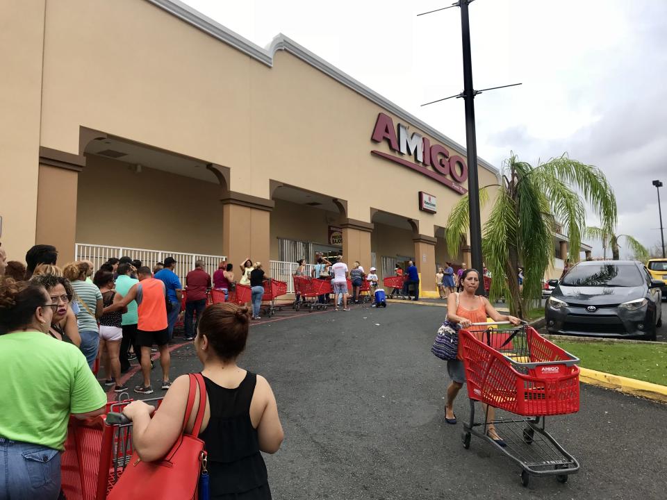<p>People wait in line for hours at the shopping center in Bayamon, Puerto Rico on Sunday Oct. 8, 2017. (Photo: Caitlin Dickson/Yahoo News) </p>