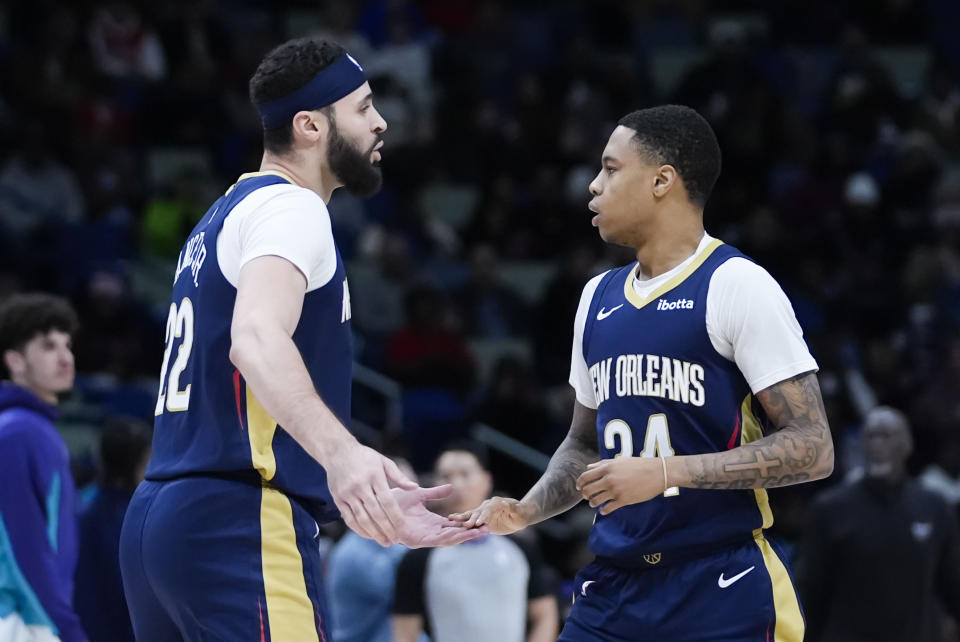 New Orleans Pelicans forward Larry Nance Jr. (22) greets guard Jordan Hawkins (24) after Hawkins' 3-point shot in the first half of an NBA basketball game against the Charlotte Hornets in New Orleans, Wednesday, Jan. 17, 2024. (AP Photo/Gerald Herbert)