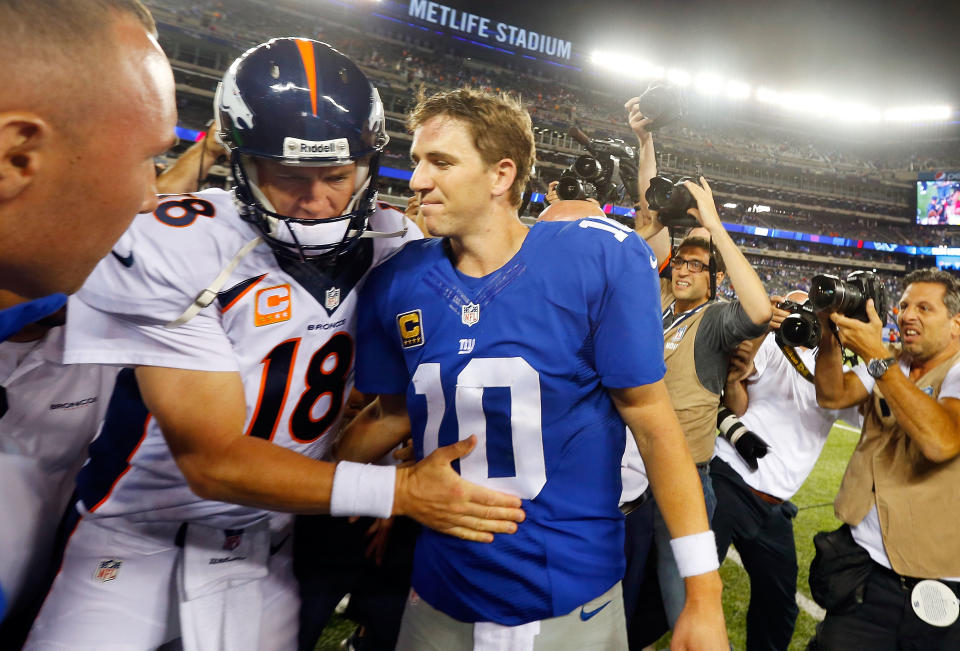 EAST RUTHERFORD, NJ - SEPTEMBER 15:  (NEW YORK DAILIES OUT)   Quarterbacks Peyton Manning #18 of the Denver Broncos and Eli Manning #10 of the New York Giants meet after their game on September 15, 2013 at MetLife Stadium in East Rutherford, New Jersey. The Broncos defeated the Giants 41-23.  (Photo by Jim McIsaac/Getty Images) 