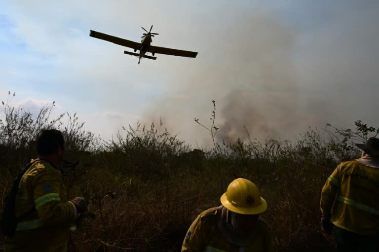 Un avión del Chico Mendes Institute for Biodiversity Conservation (ICMBio) lanza agua para combatir un foco de incedio en la zona rural de Corumbá, en el estado de Mato Grosso do Sul, Brasil, el 26 de junio de 2024 (Pablo PORCIUNCULA)