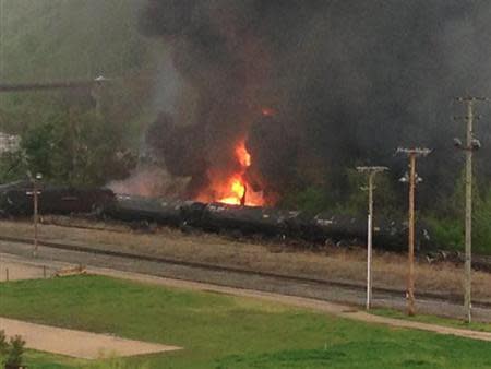 Flames are seen where a CSX Corp train carrying crude oil derailed and burst into flames in downtown Lynchburg, Virginia, April 30, 2014. REUTERS/WSET/Handout via Reuters