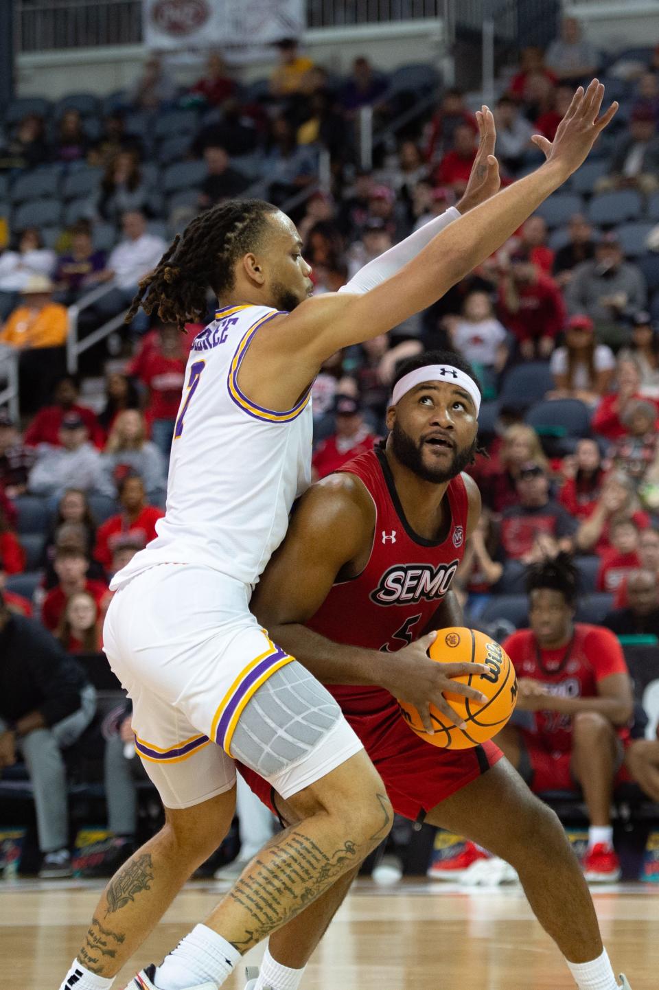 Southeast Missouri’s Chris Harris (5) looks for an opening to make a basket around Tennessee Tech’s Jaylen Sebree (2) during the OVC men's championship at Ford Center on Saturday, March 4, 2023.