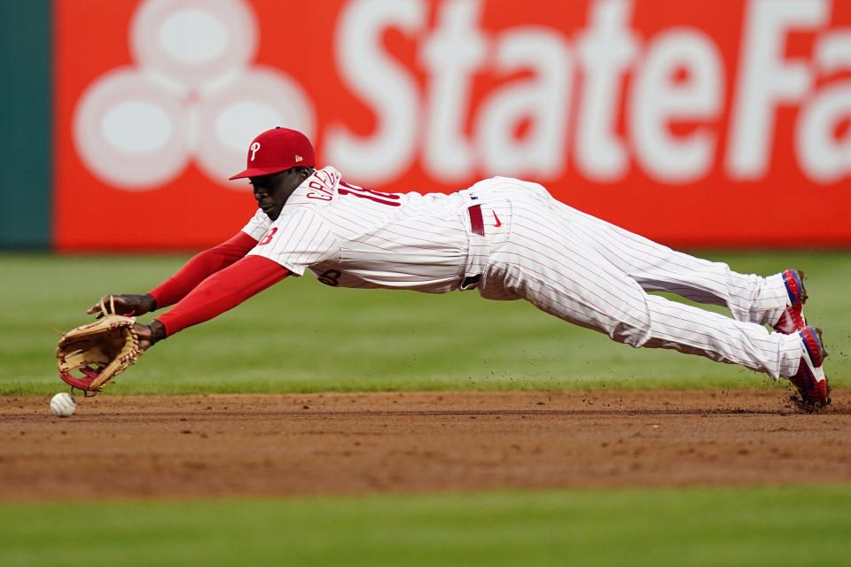 Philadelphia Phillies shortstop Didi Gregorius cannot reach a run-scoring single by Colorado Rockies' Connor Joe during the third inning of a baseball game, Wednesday, April 27, 2022, in Philadelphia. (AP Photo/Matt Slocum)