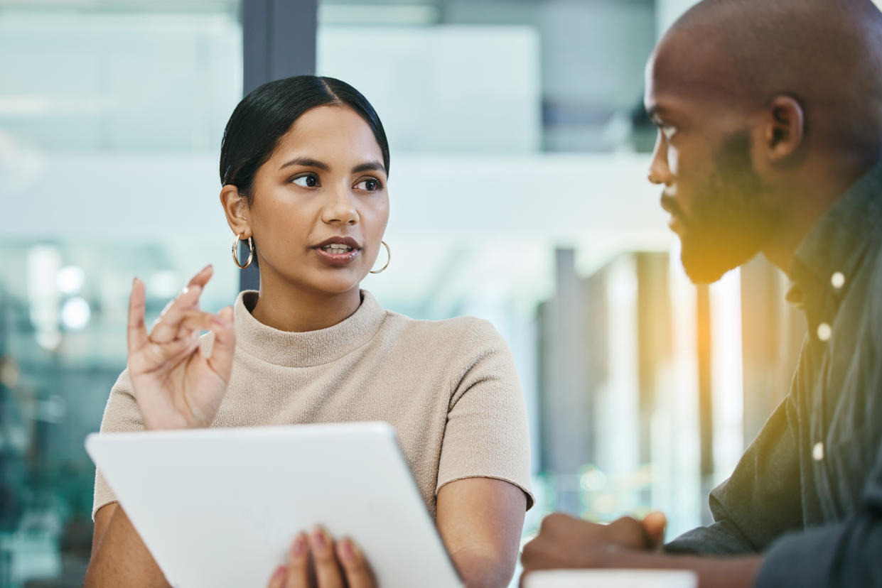 Picture of a man and woman at work, following news that this year's Equal Pay Day falls on November 22. (Getty Images)