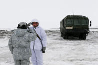 An officer on duty salutes reporting to another officer as the Bastion anti-ship missile systems take positions on the Alexandra Land island near Nagurskoye, Russia, Monday, May 17, 2021. Once a desolate home mostly to polar bears, Russia's northernmost military outpost is bristling with missiles and radar and its extended runway can handle all types of aircraft, including nuclear-capable strategic bombers, projecting Moscow's power and influence across the Arctic amid intensifying international competition for the region's vast resources. (AP Photo/Alexander Zemlianichenko)