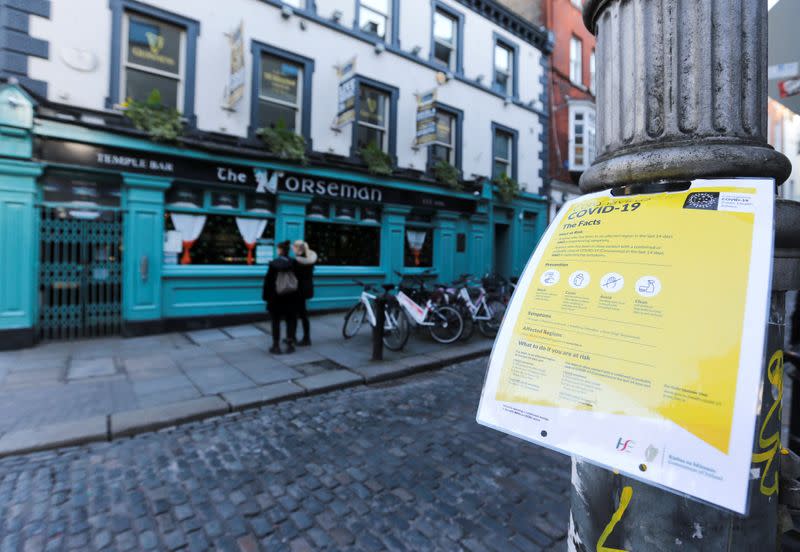 A notice about coronavirus is pictured as pub doors are locked in the Temple Bar area, as bars across Ireland close voluntarily to curb the spread of coronavirus in Dublin