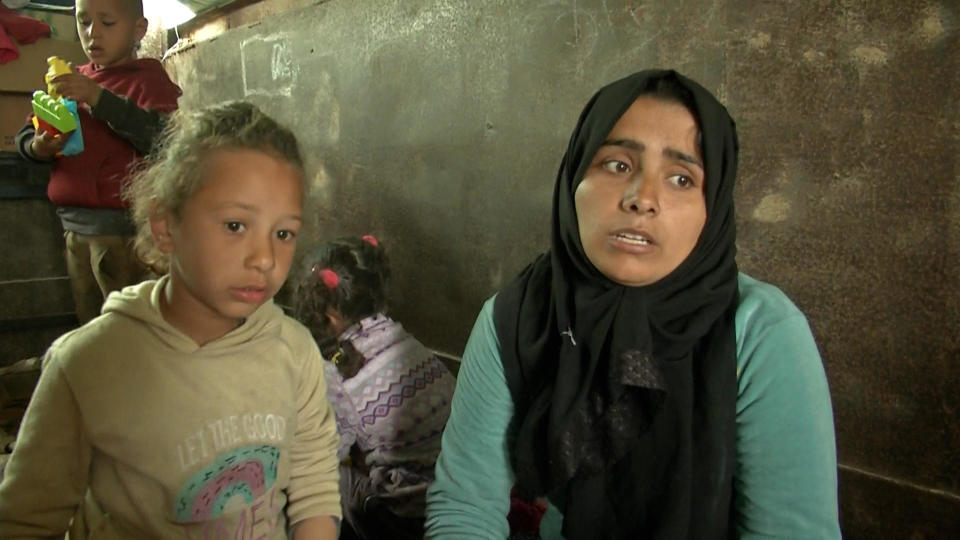 Palestinian Mariam Abu Eida sits with one of her children as she speaks with CBS News inside the truck her family is using as a shelter in the demilitarized zone known as the Philadelphi Corridor along the southern Gaza border with Egypt, Jan. 17, 2024. / Credit: CBS News