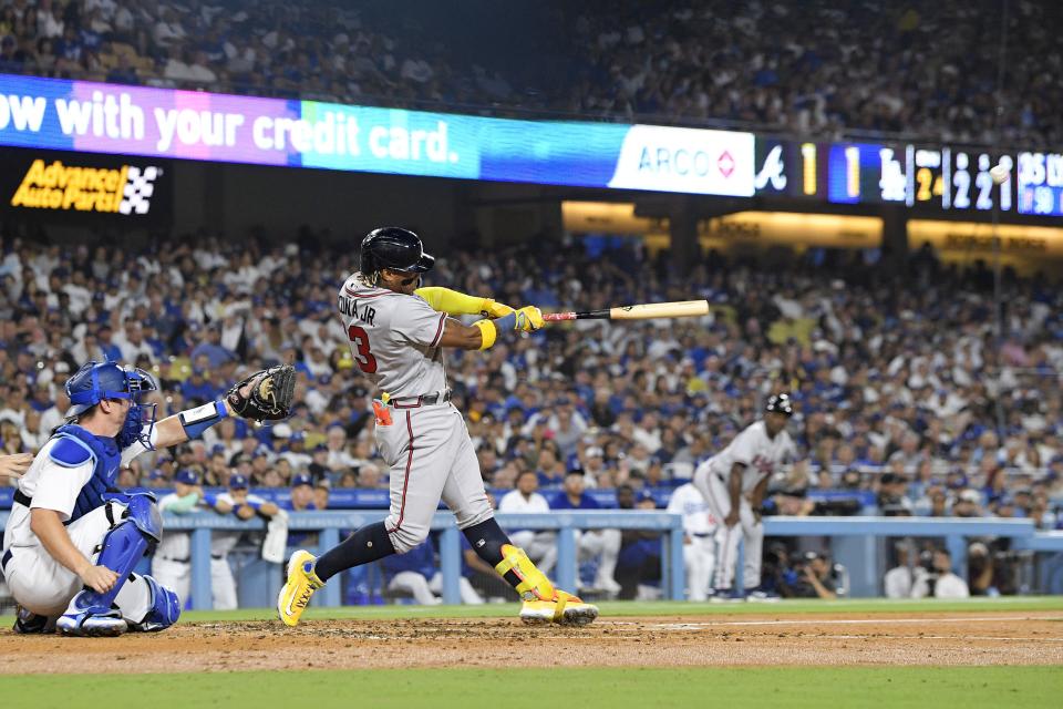 Atlanta Braves' Ronald Acuna Jr., right, hits a grand slam as Los Angeles Dodgers catcher Will Smith watches during the second inning of a baseball game Thursday, Aug. 31, 2023, in Los Angeles. (AP Photo/Mark J. Terrill)