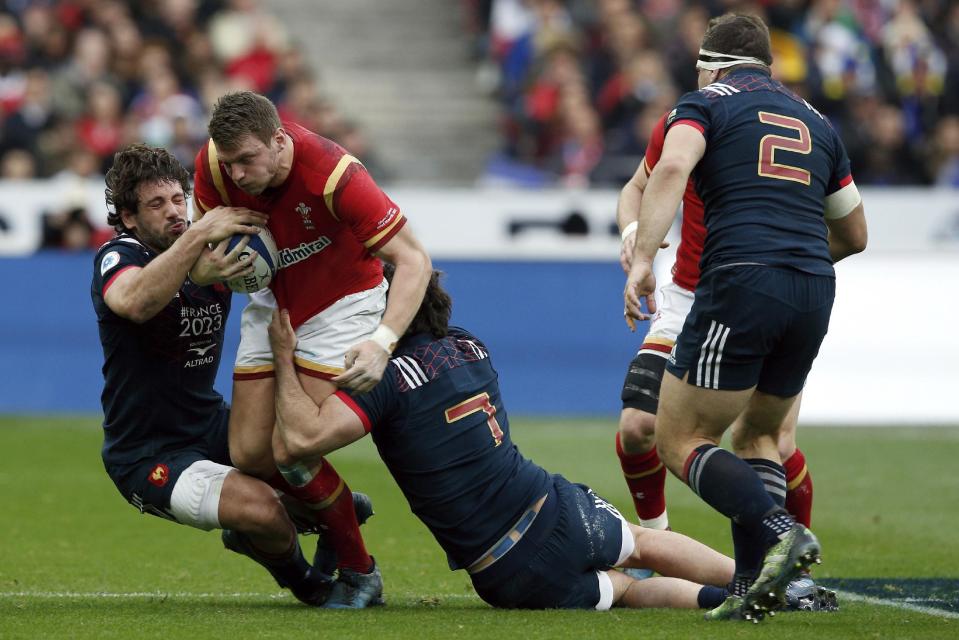 Wales' Scott Williams is tackled by France's Remi Lamerat, left, and Kevin Gourdon during a Six Nations rugby union international match between France and Wales at the Stade de France stadium, in Saint Denis, north of Paris, Saturday, March 18, 2017. (AP Photo/Thibault Camus)