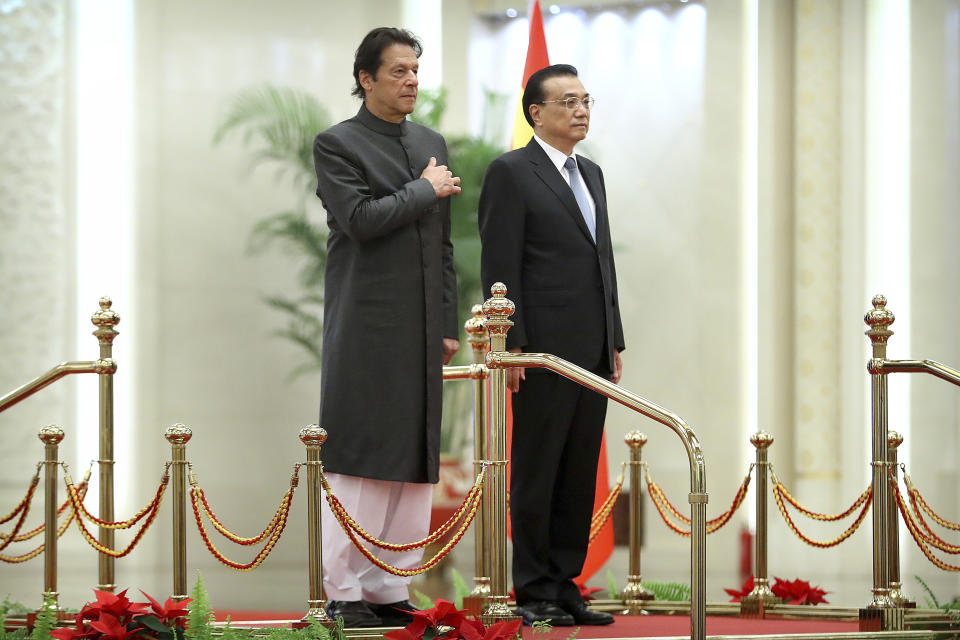 Pakistan's Prime Minister Imran Khan, left, and Chinese Premier Li Keqiang stand together during a welcome ceremony at the Great Hall of the People in Beijing, Saturday, Nov. 3, 2018. (AP Photo/Mark Schiefelbein)