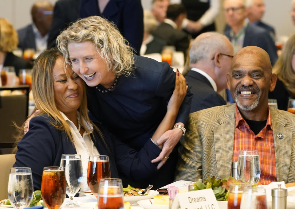 Virginia State Sen. Jen Kiggans, center, R-Virginia Beach, greets supporters as she prepares for a debate sponsored by the Hampton roads Chamber of Congress Wednesday, Oct. 12, 2022, in Virginia Beach. Va. (AP Photo/Steve Helber)