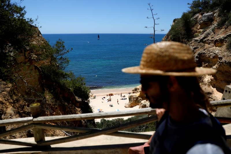 FILE PHOTO: People arrive at Marinha beach amid the COVID-19 pandemic in Albufeira