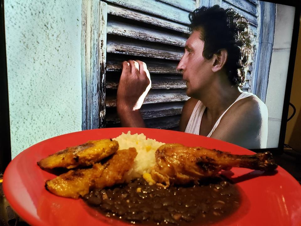 Alexis Díaz de Villegas as Juan in "Juan de los Muertos" and a plate of roasted chicken