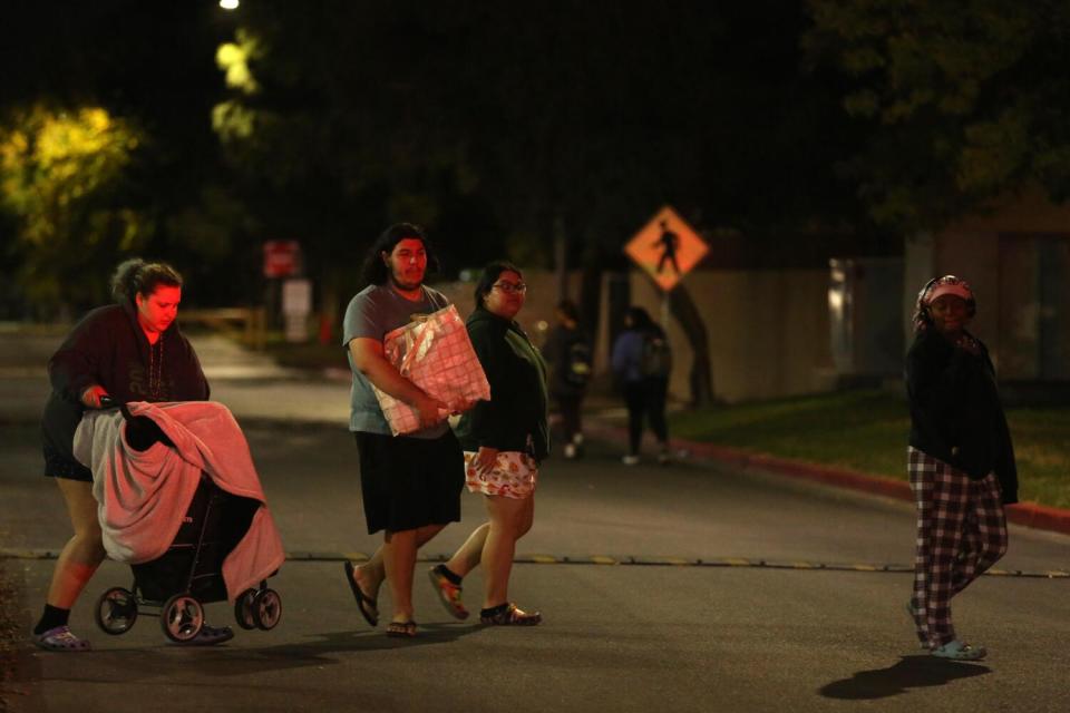 Students walk with their belongings.