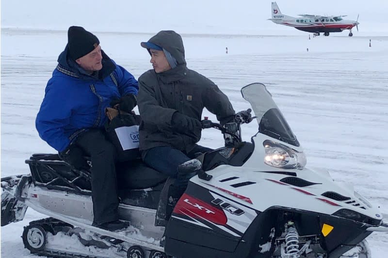 U.S. Census Bureau director Steven Dillingham rides on a snowmobile in Toksook Bay